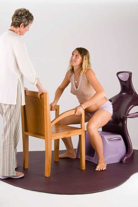 Midwife assisting woman to stand up in Floor Studio
